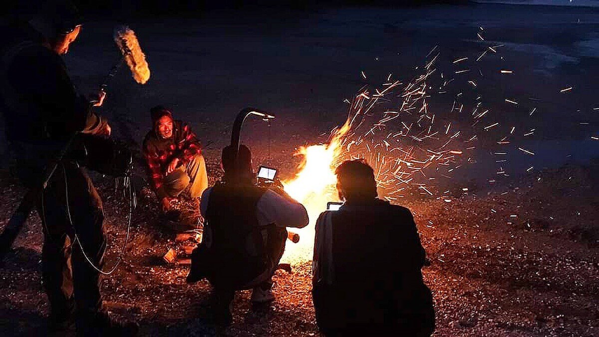 Auckland filmmaker working with professional camera and audio equipment on location