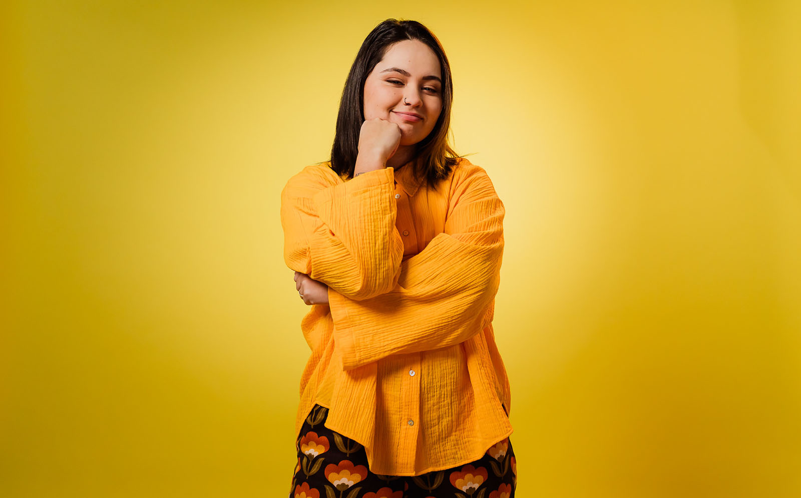 Portrait of Paige, singer-songwriter from South Auckland, photographed for Mental Health Awareness Week campaign with yellow backdrop